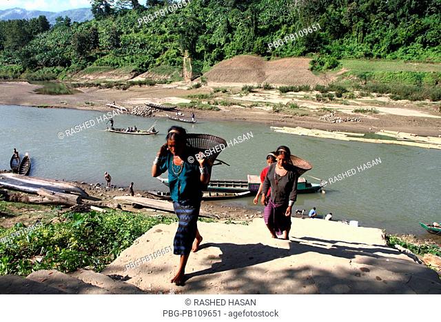 Ethnic women carry basket on their back at the bank of Sangu river at Thanchi Bandarban, Bangladesh November 2010