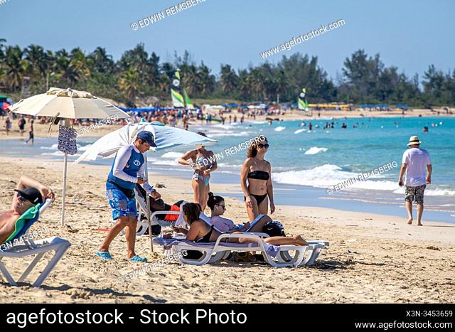 People enjoying the sun at Santa Maria del Mar beach , Havana, Cuba