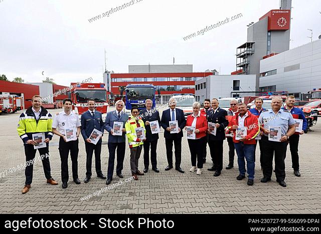 27 July 2023, Bavaria, Nuremberg: Minister of the Interior Joachim Herrmann (CSU, 7th from left) presents the new Civil Protection Concept 2025 for Bavaria with...