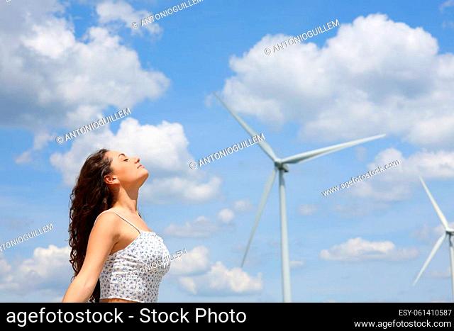Profile of a woman breathing fresh air in a wind farm