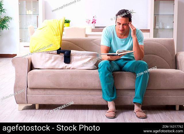 Young man parent looking after newborn at home