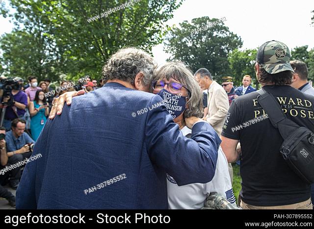 Susan Zeier gets a hug from United States Senator Sherrod Brown (Democrat of Ohio) during a press conference after a Senate procedural vote to advance...