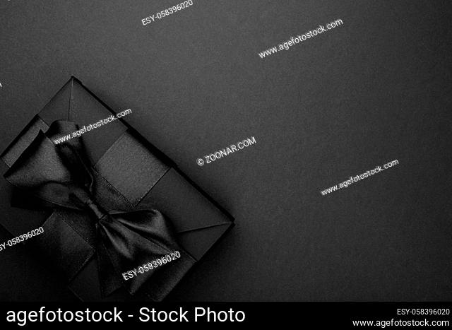 Black friday sale background with box gift present with satin ribbon bow copy space for text