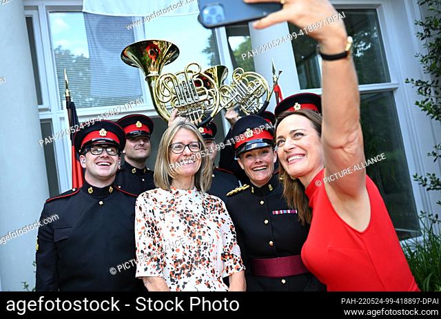 24 May 2022, Berlin: Jill Gallard (l) , British Ambassador to the Federal Republic of Germany and Sarah Willis, horn player take a photo with the Sandhurst...
