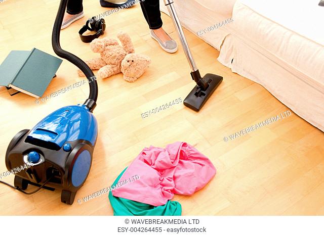 Woman vacuuming the living-room