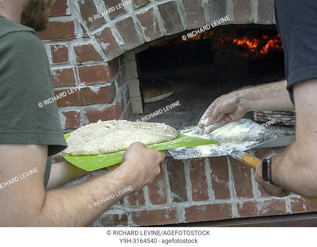 Bakers cook artisanal bread and pizza in a wood-fired oven in Brooklyn in New York on Sunday, August 19, 2018. (© Richard B. Levine)