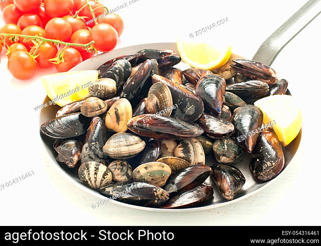 mussels cooked in a pan with garlic and tomato, italy