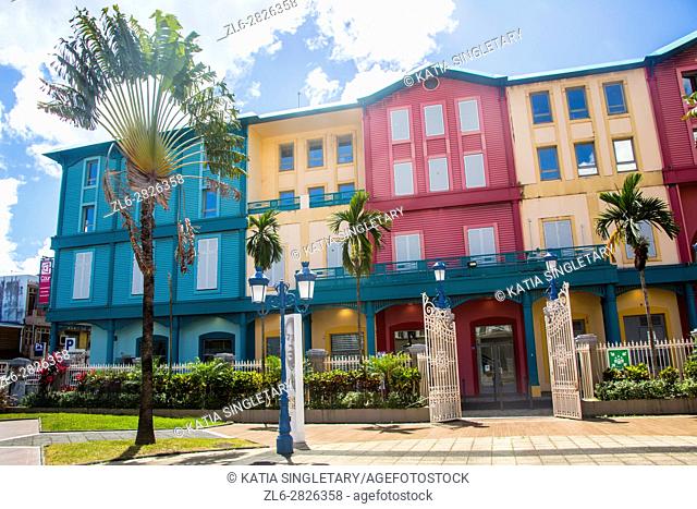 Gorgeous city hall that was a theater cinema with gorgeous palm trees and colorful houses yellow, purple and blue surrounding it