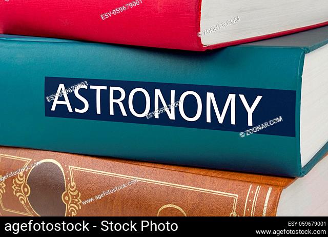 A book with the title Astronomy written on the spine