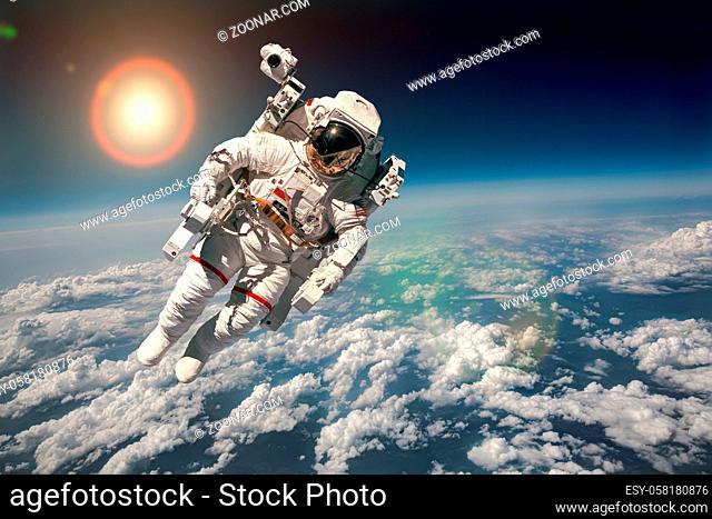 Astronaut in outer space against the backdrop of the planet earth. Elements of this image furnished by NASA