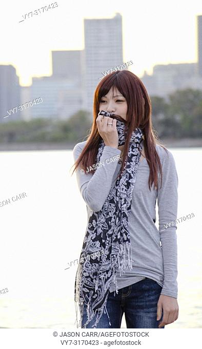 Japanese Girl poses on the street in Odaiba, Japan. Odaiba is a area by the sea in Tokyo