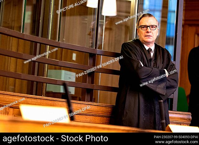 07 February 2023, Berlin: Mark Höfler, lawyer for the defendant, stands next to the defendant's empty seat in the courtroom at the start of the trial following...