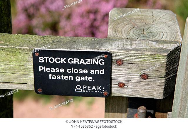 Gate sign asking people to close and fasten the gate because of stock grazing, Peak District National Park, England, UK