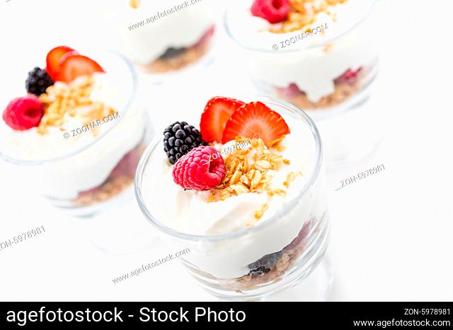 Breakfast parfait made from Greek yogurt and granola topped with fresh berries