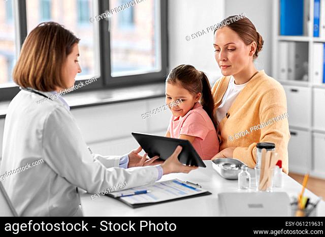 mother, child and doctor with tablet pc at clinic