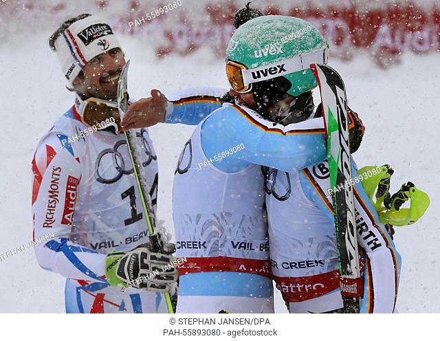 Felix Neureuter (R) and Fritz Dopfer of Germany react beside gold medal winner Jean Baptiste Grange of France (L) after the mens slalom at the Alpine Skiing...