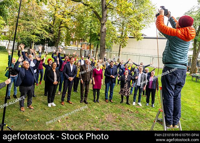 18 October 2023, Bavaria, Munich: The new parliamentary group of Bündnis 90/Die Grünen in Bavaria stands together for a group photo on a meadow after their...