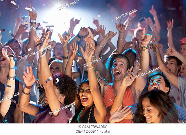 Enthusiastic crowd cheering at concert