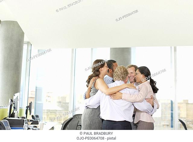 Businesspeople in huddle in office