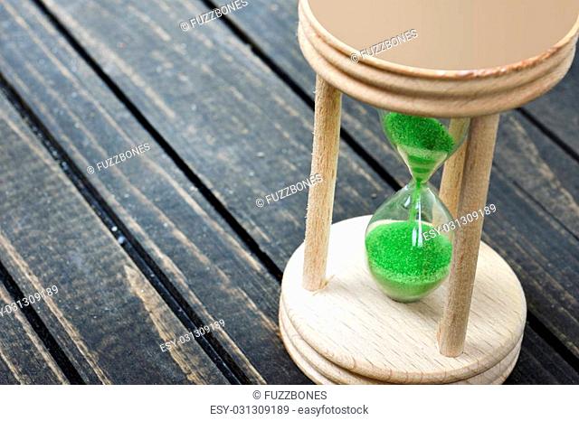 Hourglass close-up on wooden table
