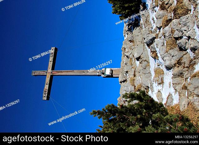 Winter hike through the mountain forest to the Simetsberg. Germany, Bavaria, Walchensee, Einsiedl, summit cross at 1840m