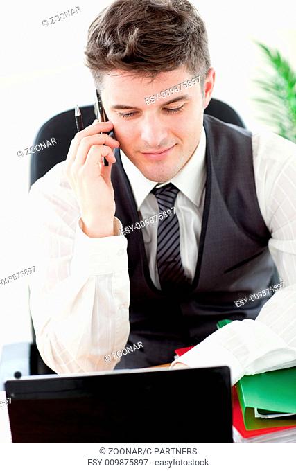 Confident young businessman talking on phone