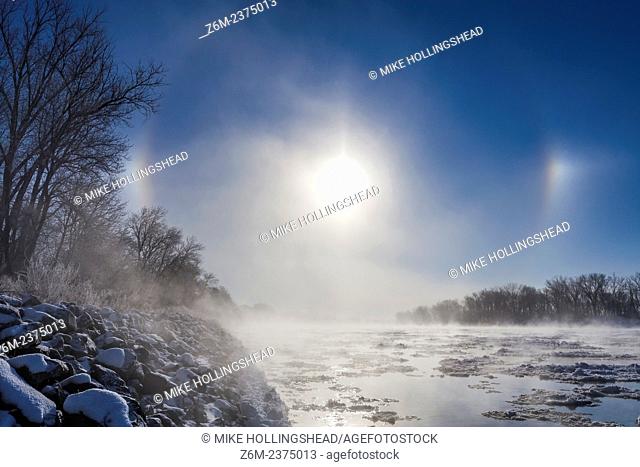 Sun dogs form over western Iowa thanks to ice crystals off a steamy Missouri River during a very cold morning