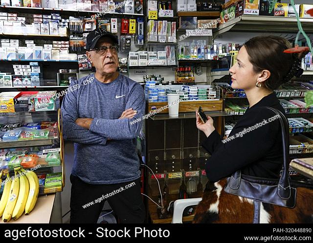 Journalist Georgia Worrell speaks with a store owner in the Dupont Circle section of Washington D.C. on Friday, October 14 2022 in Washington D.C