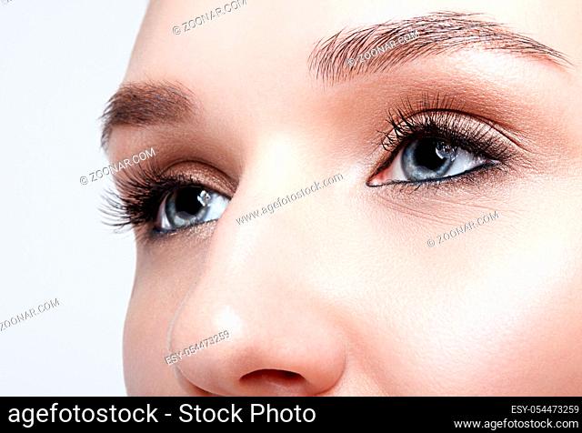 Closeup macro shot of blue human woman eye. Female with smoky eyes makeup