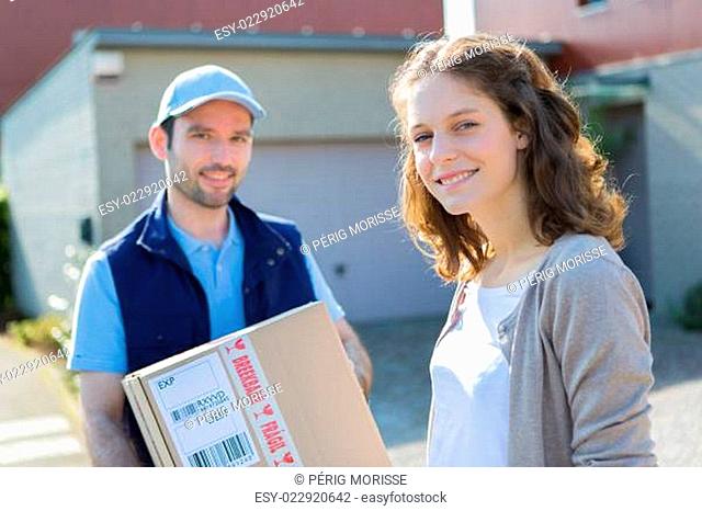 Young attractive delivery man on his way to customer