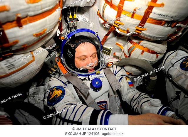 Russian cosmonaut Fyodor Yurchikhin, Expedition 24 flight engineer, attired in his Russian Sokol launch and entry suit, occupies his seat in the Soyuz TMA-19...