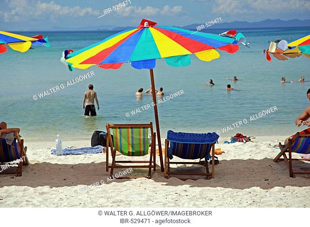 Beach with sun shades, deck chairs and tourists, Kho Phi Phi, Thailand, Asia