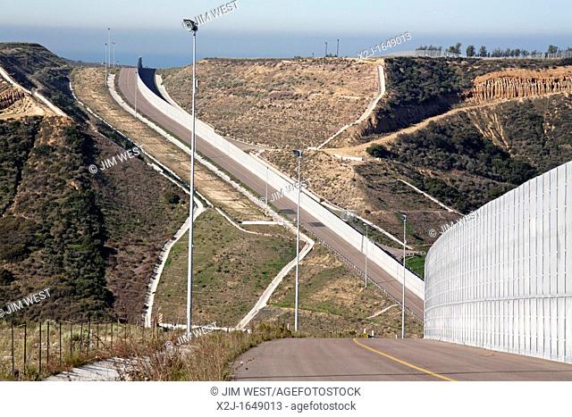 San Ysidro, California - The Border Patrol's new all-weather patrol road and fence along international border between the United States and Mexico  Mexico is...