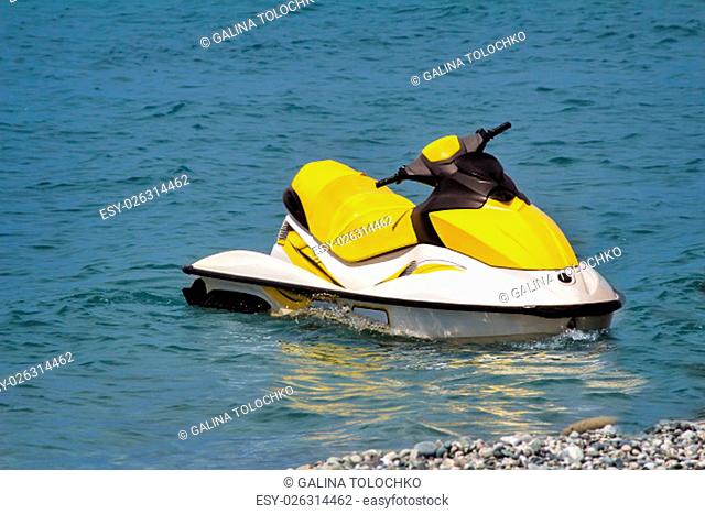 In coastal water on the beach is a small single motor boat vacationers