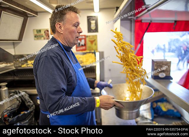 15 March 2022, Poland, Przemysl: Franky from the Netherlands prepares French fries for refugees from Ukraine in a mobile snack bar brought here by a group of...