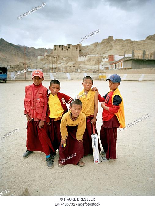 Jun-Juns, young monks playing cricket on a polo yard underneath Royal Palace, Leh, Ladakh, Jammu and Kashmir, India