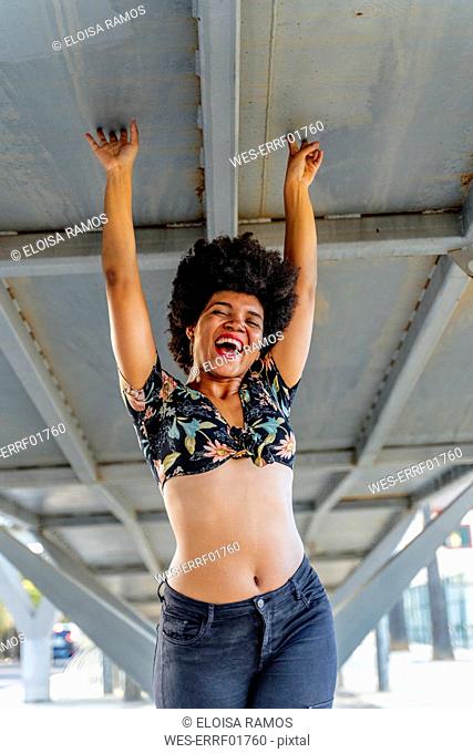 Laughing Afro-American with raised arms