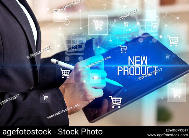 Young person makes a purchase through online shopping application with NEW PRODUCT inscription