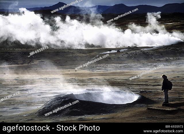 Geothermal area, woman standing at solfatare, hot fumarole, steam, post volcanic exhalations, tourists, Námaskarð, Mývatn, Iceland, Europe