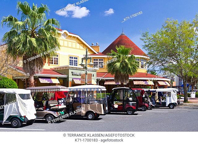 Golf carts and automobiles on the street at Sumter Lake Landing at The Villages, Florida, USA