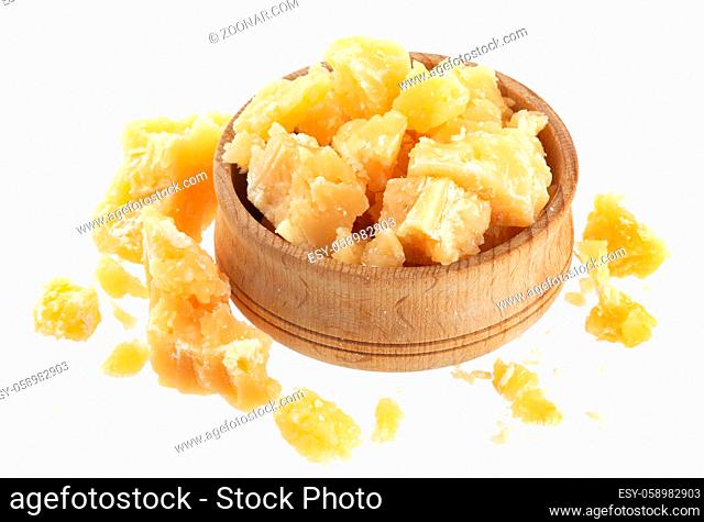 Parmesan cheese in wooden bowl isolated on white background, broken parmigiano