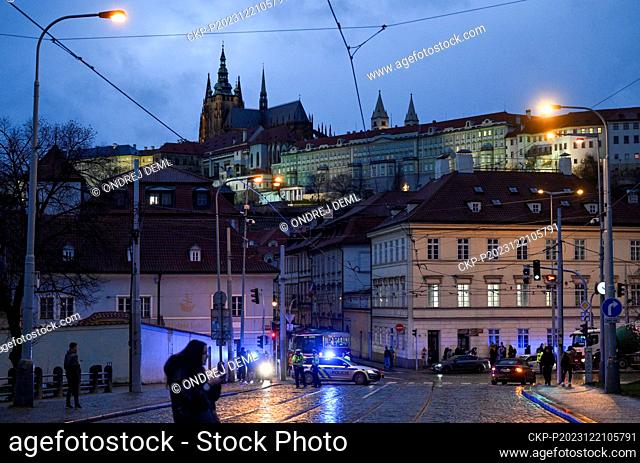 A police officer patrols the closed Manes Bridge heading towards Prague Castle, where shots were fired in the Faculty of Arts building, in Prague