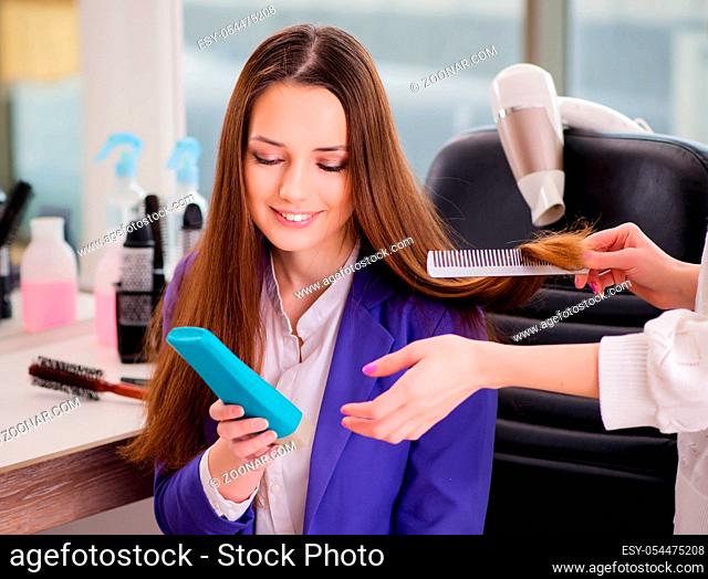 The woman getting her hair done in beauty shop
