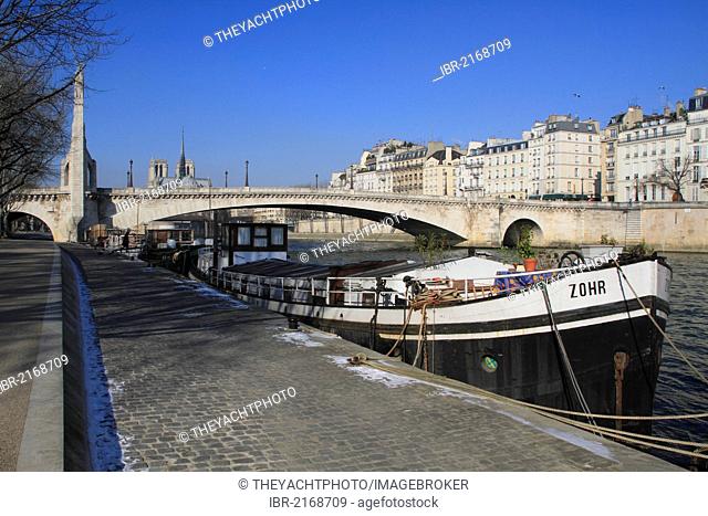 Seine river with the bridge Pont La Tournelle and a cargo ship, Notre-Dame, Paris, France, Europe