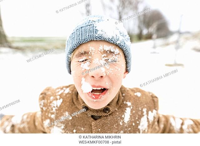 Portrait of boy with snow in his face