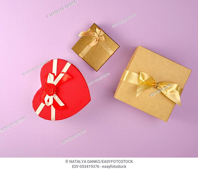 cardboard holiday boxes on a purple background, top view