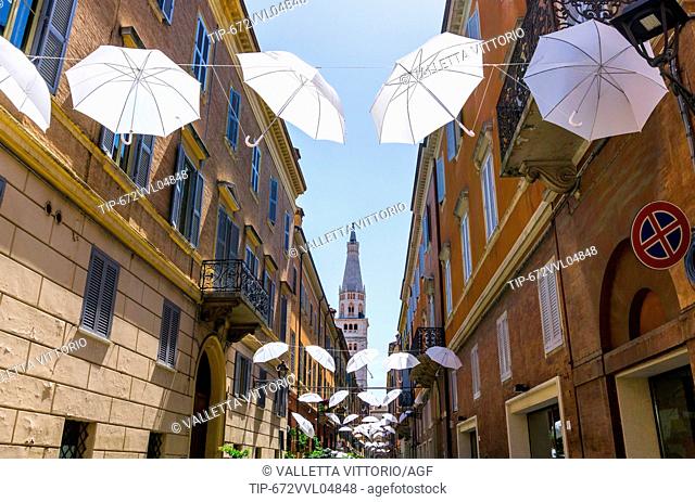 Italy, Emilia Romagna, Modena, hanged umbrella, cathedral belfry in background