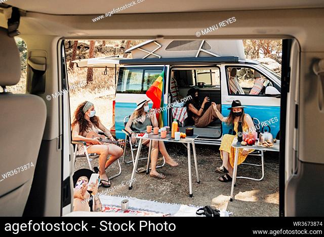 Women with protective masks during their camper van trip