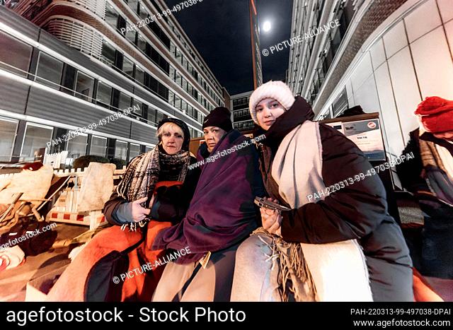 12 March 2022, Hamburg: Three women from Ukraine wait in front of the Hammer Straße registration office. They hold out overnight in order not to lose their...