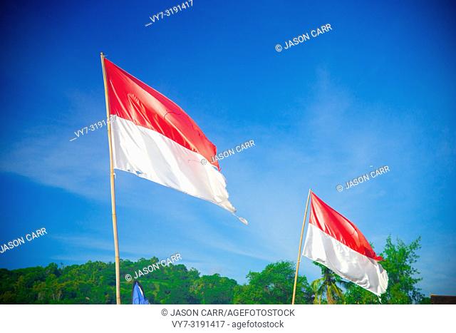 Indonesian Flag nearby the ocean in Bali, Indonesia. Bali is an Indonesian island and known as a tourist destination